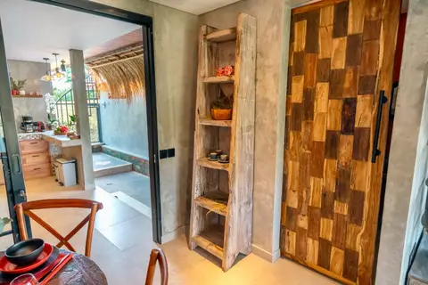 Joglo Hati: wooden shelf and doors in the living area