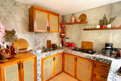 Joglo Hati: kitchen counter with wooden cabinets
