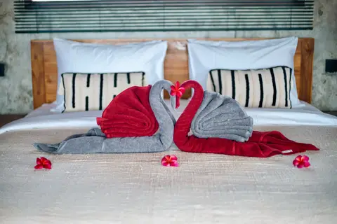 Joglo Hati: towel swans on the bed in the Madu house