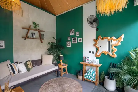 Villa Mint Satu: sofa in front of the green wall