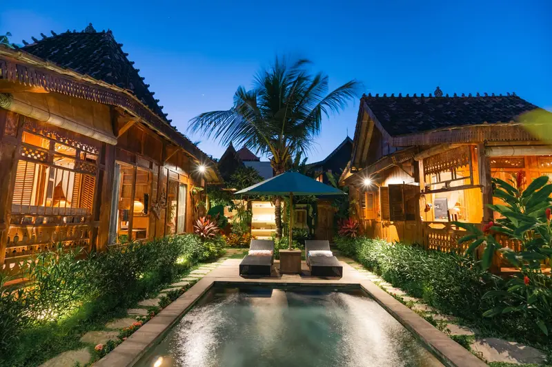 Rumah Richard: cottages and garden lit up at dusk
